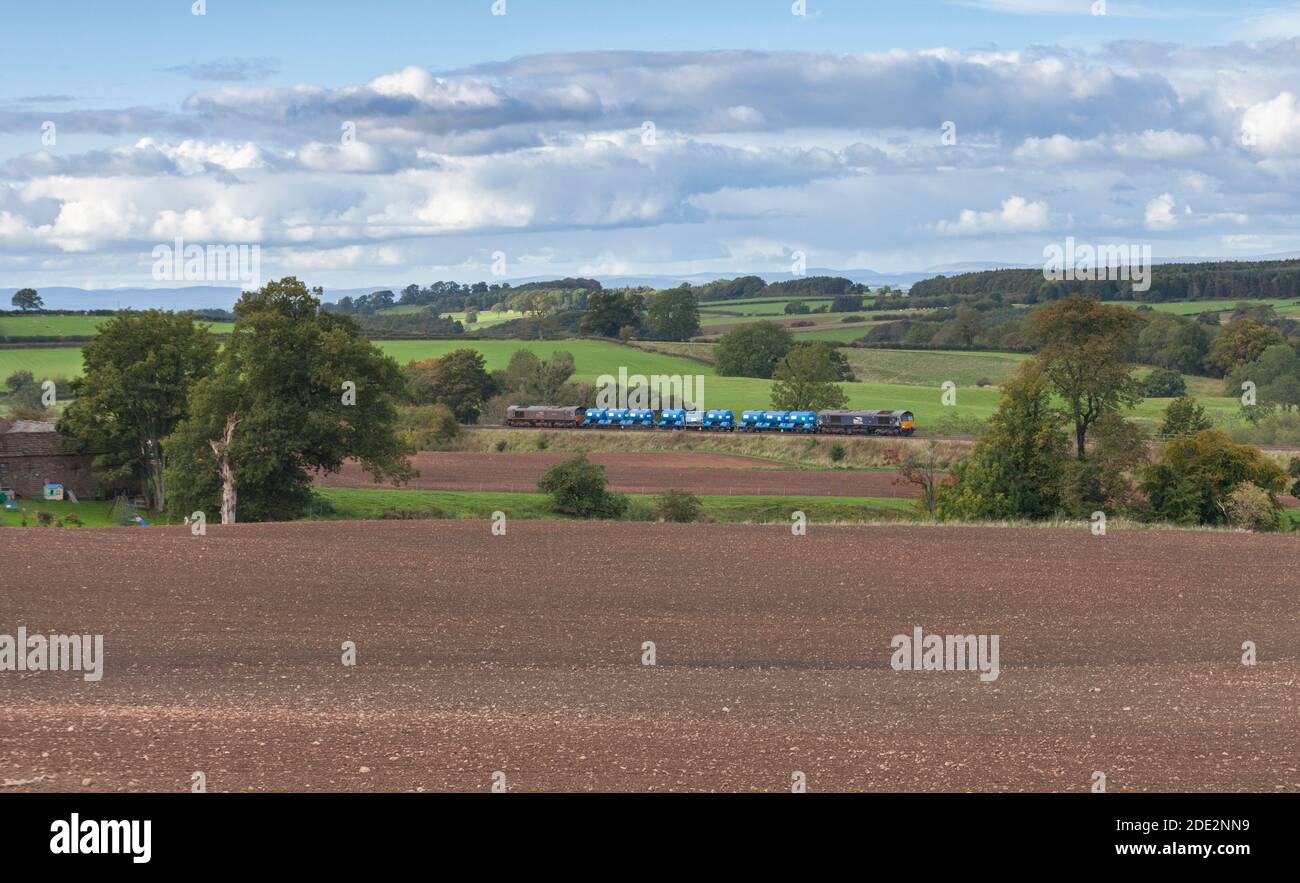 Direct Rail Services class 66 locomotives in the countryside with a Network Rail Railhead treatment train ( RHTT ) dealing with autumn leaves Stock Photo