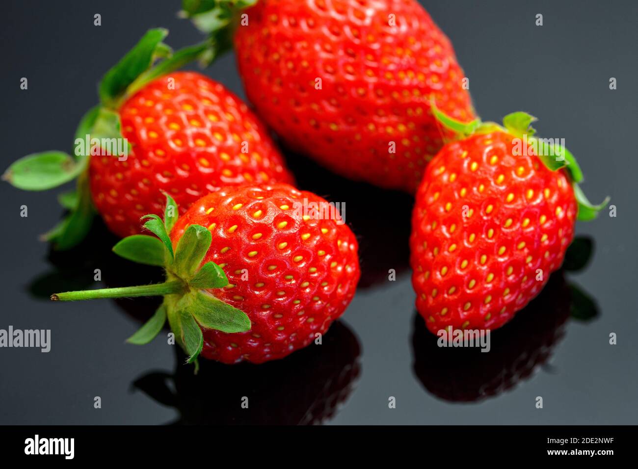 Macro image of fresh red strawberries group isolated at black ...