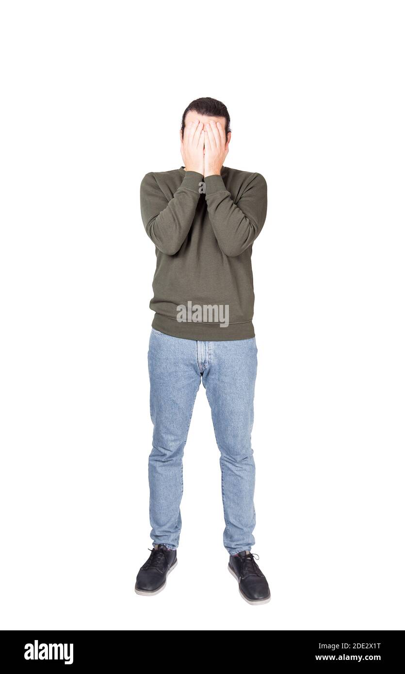 Full length portrait of disappointed young man, facepalm gesture, covering face with his hands. Depressed person suffering emotional breakdown and fai Stock Photo