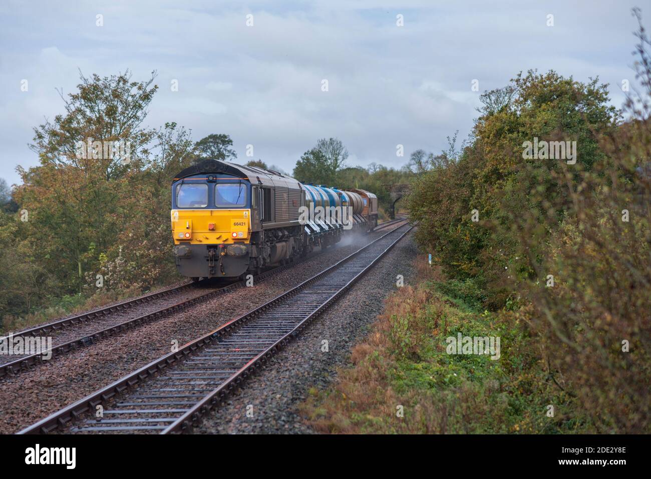 Direct Rail Services class 66 locomotives hauling a Network rail Railhead treatment train ( RHTT ) dealing with autumn leaves Stock Photo