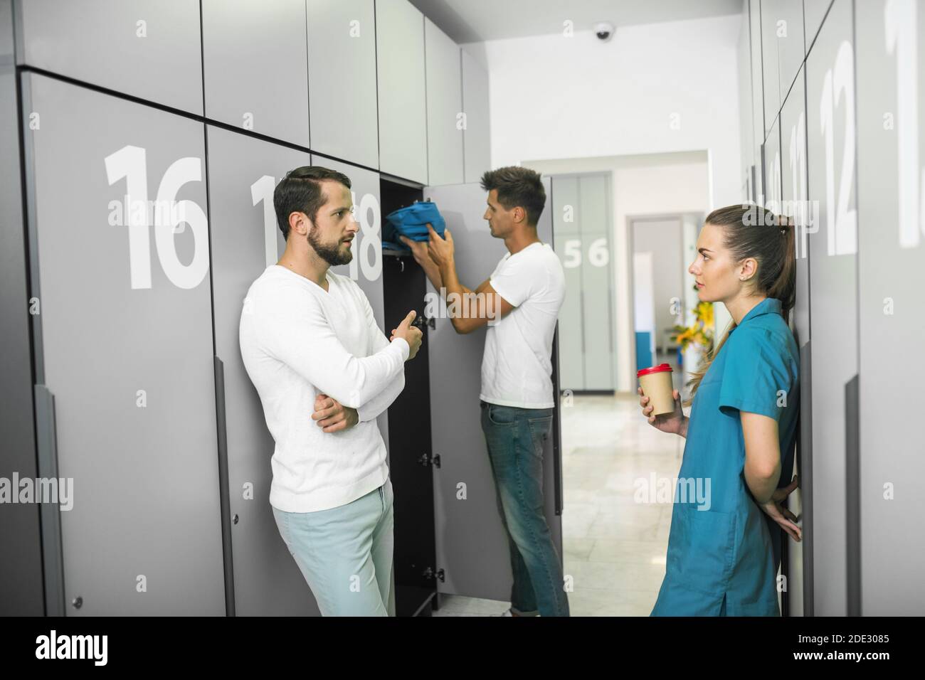 Group of people standing in the changing room Stock Photo