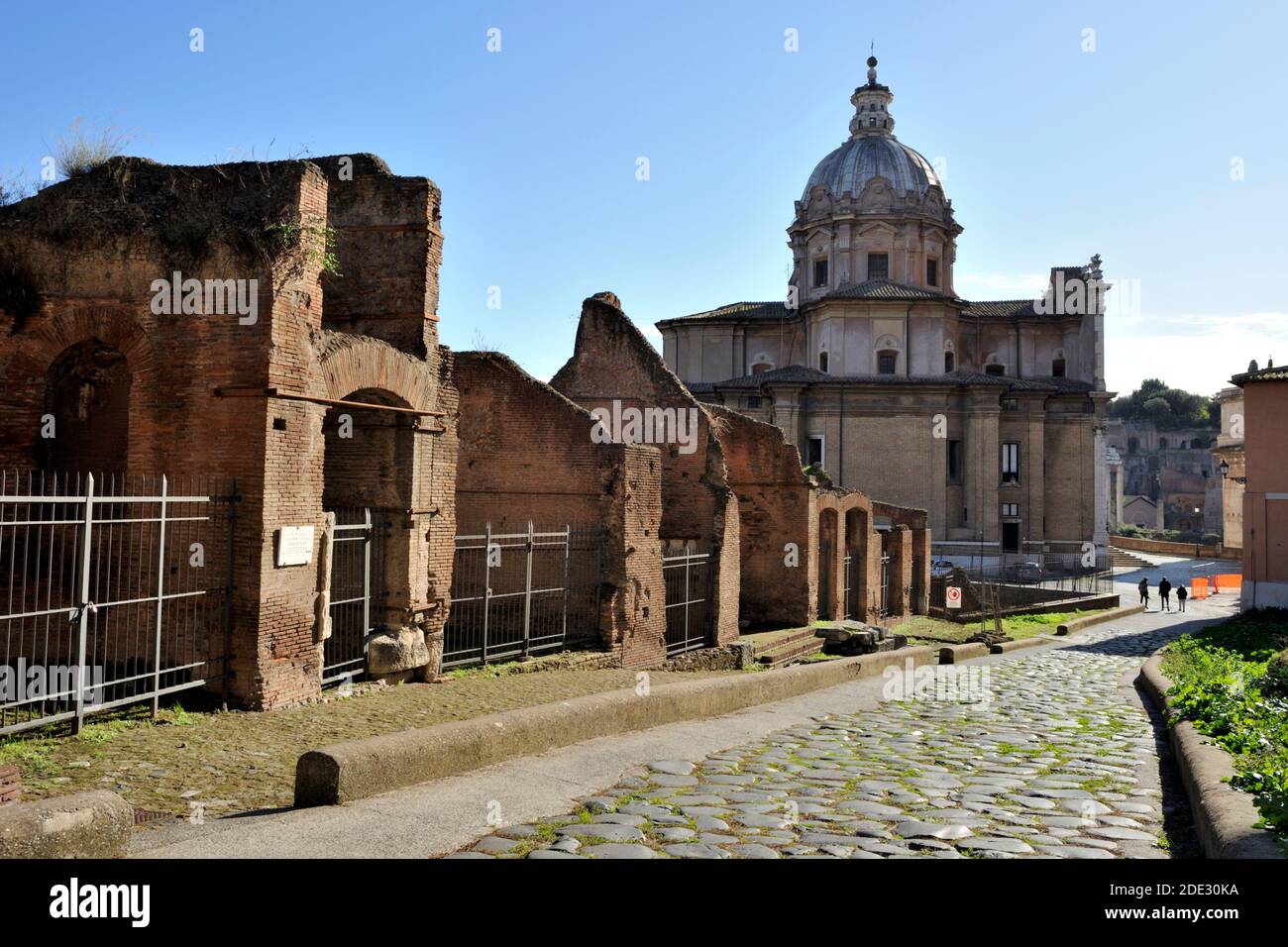 Ancient roman cobbled street, Forum of Caesar and church of Santi Luca and Martina, Clivo Argentario, Rome, Italy Stock Photo