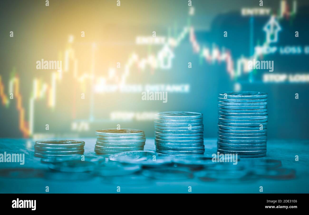 Double exposure of money coin, stock market or forex trading graph and candlestick chart suitable for financial investment concept. Stock Photo