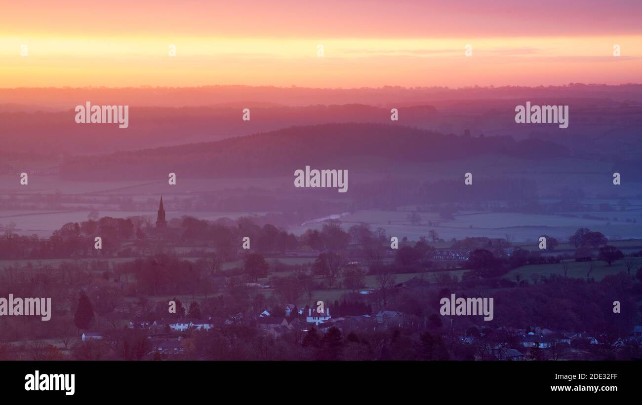 The sky above Weeton in the Lower Wharfe Valley glows with vibrant sunrise colour at sunrise on a late November morning. Stock Photo