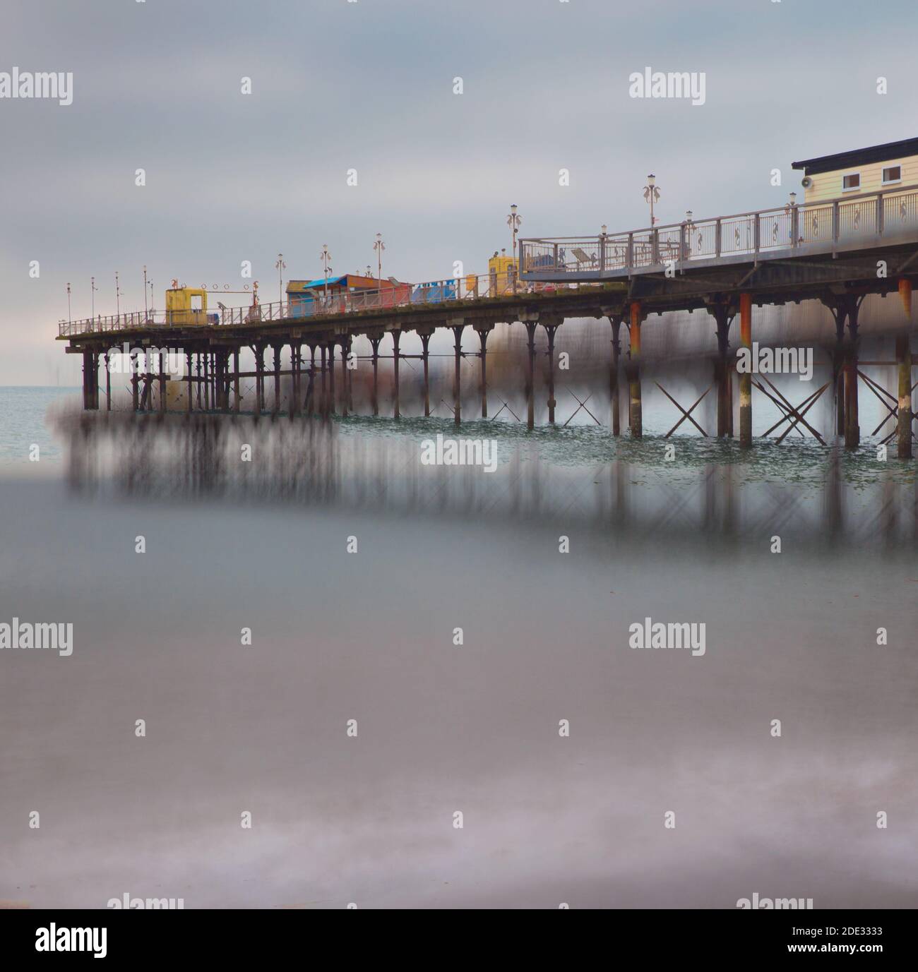 A long exposure of a Pier with reflections in the water. Stock Photo