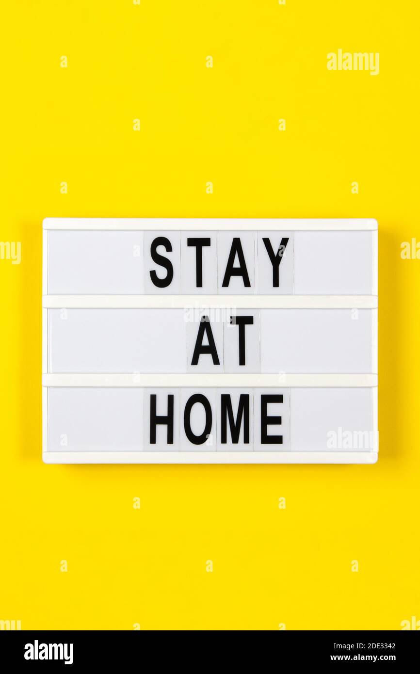 Lightbox with text STAY AT HOME on yellow background. Healthcare ...
