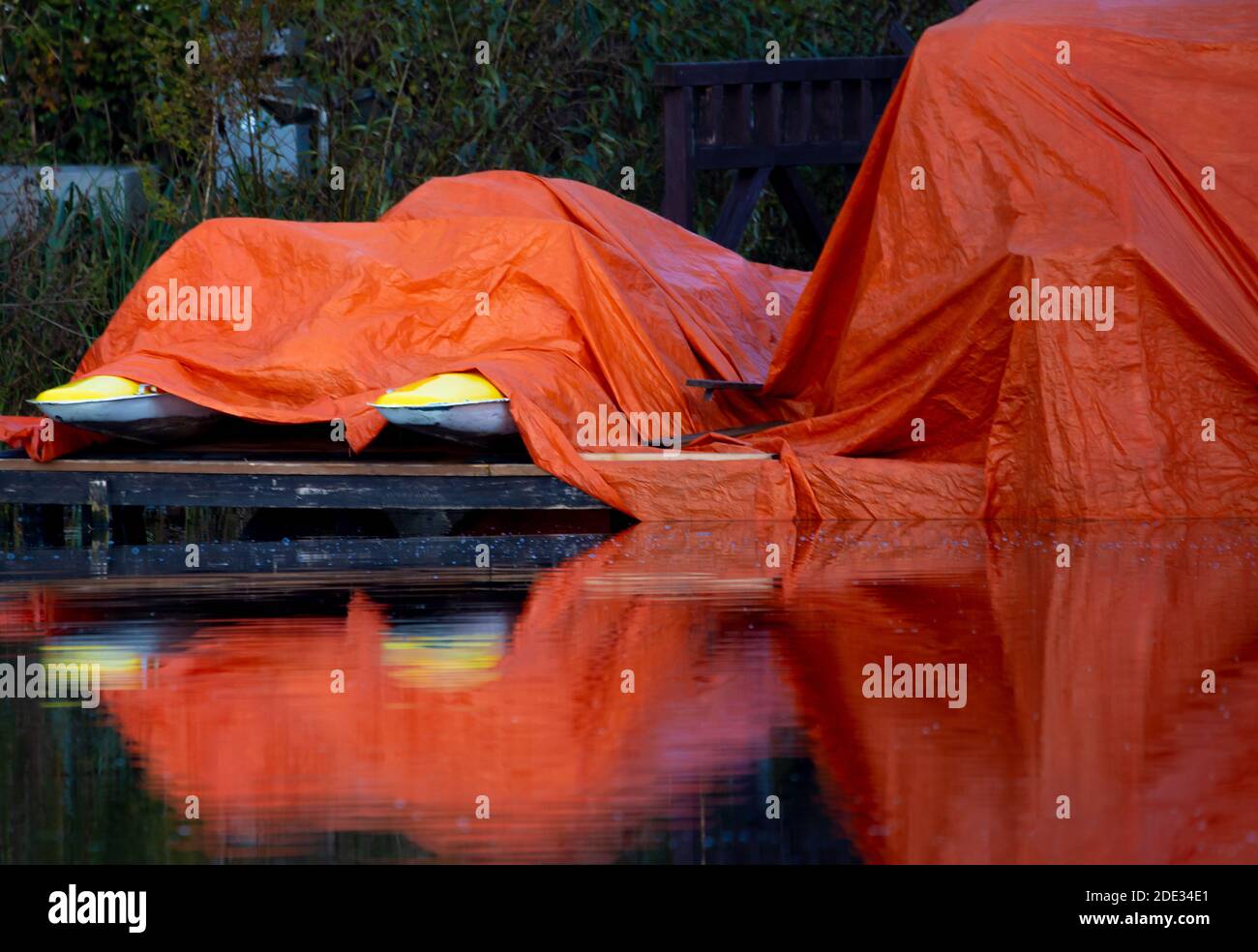 This huge red tarpaulin for boats can be seen from afar. Dieksee, Malente, Germany. Stock Photo