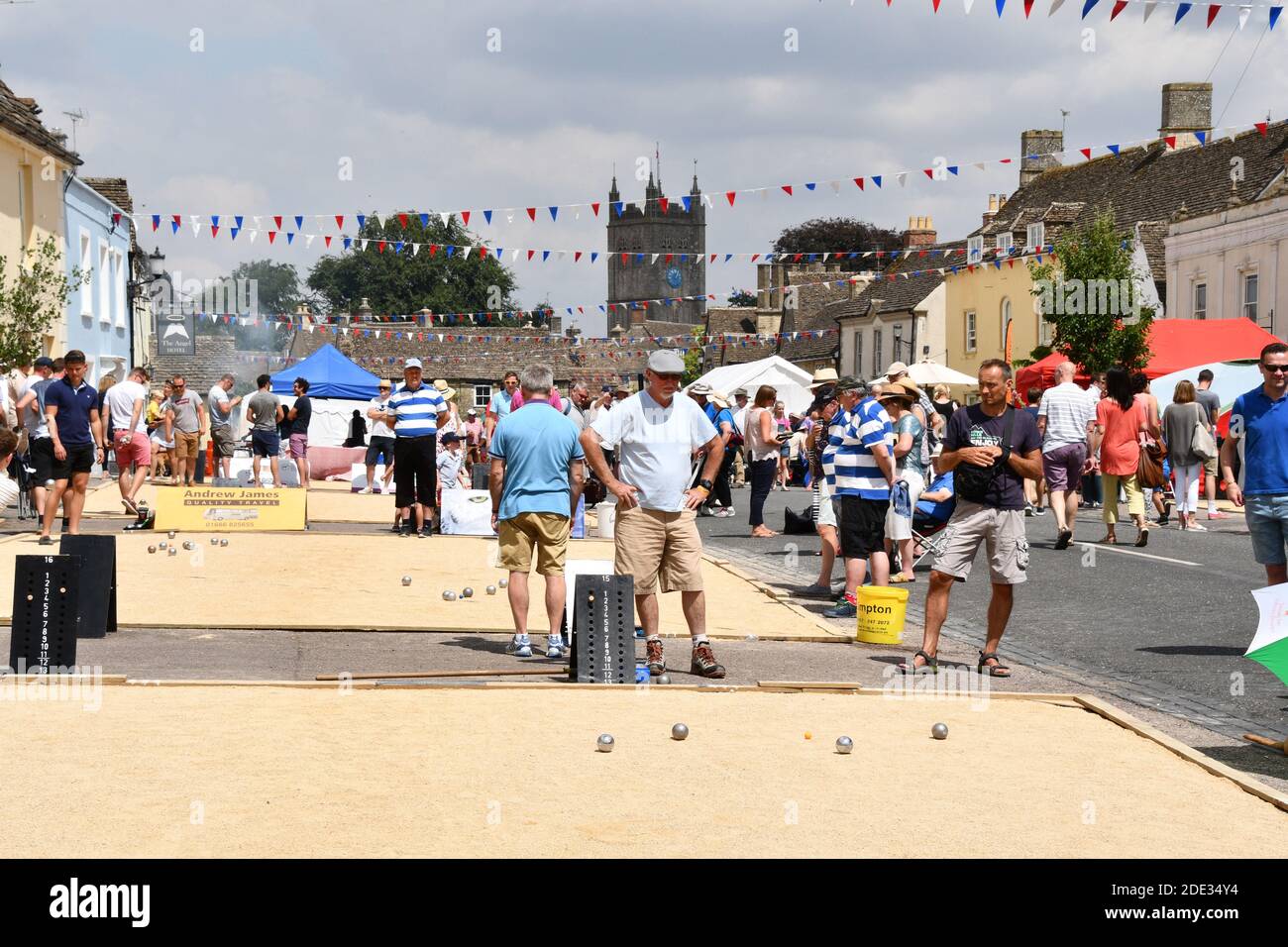 Keen players concentrating hard at the International Boules competition, an annual event held in the wide High street of Sherston,Wiltshire, UK Stock Photo