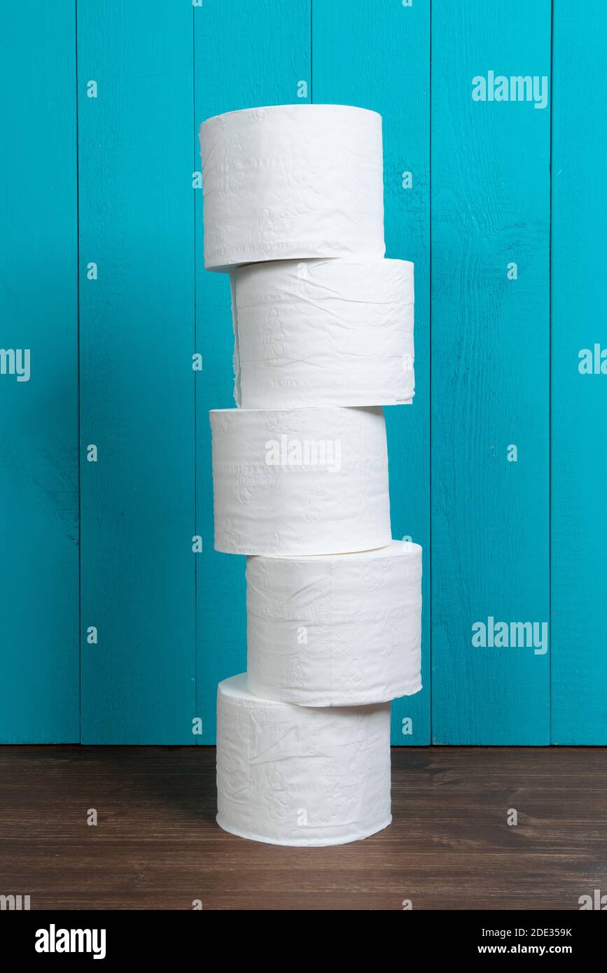 some rolls of toilet paper on a wooden table Stock Photo