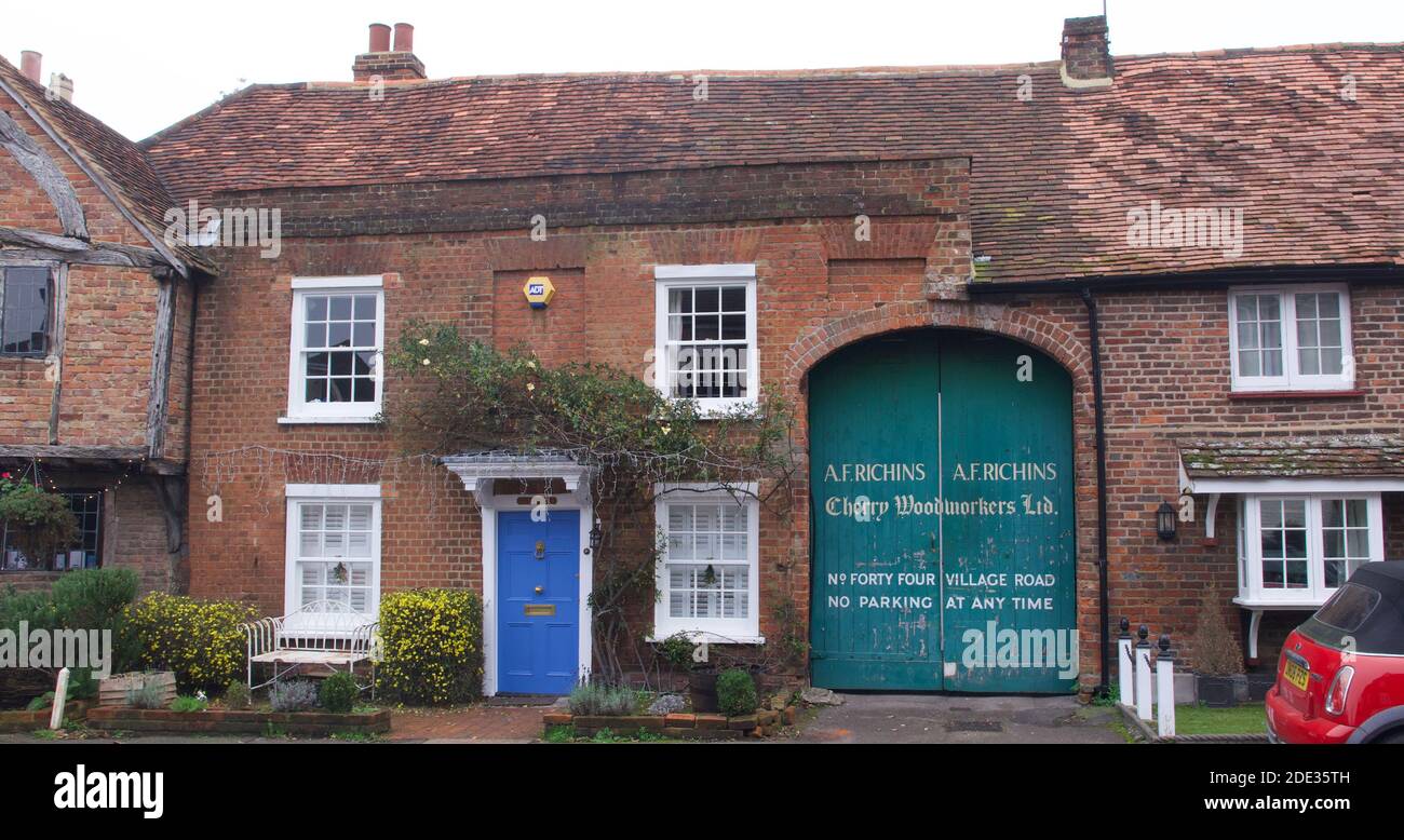 28 November 2020 - Denham, England: Charming village houses with trade door Stock Photo