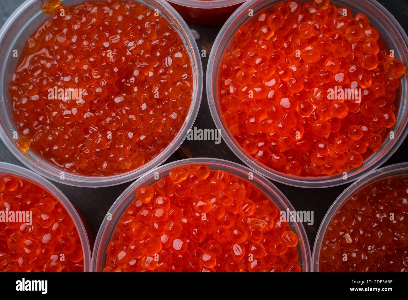 Pink salmon caviar and chum salmon caviar in plastic containers