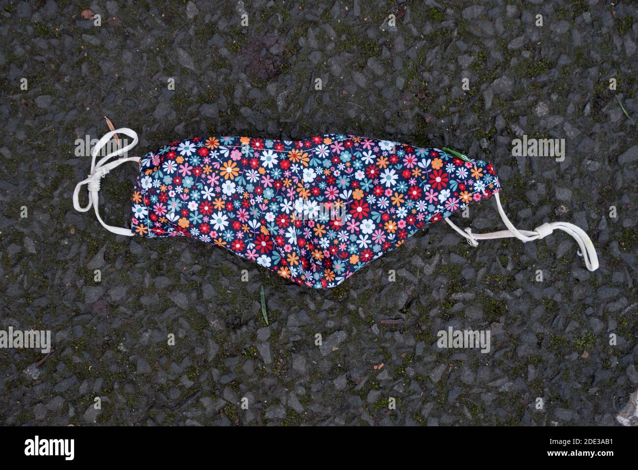 Lost face mask lying on the pavement in Edinburgh, Scotland, UK Stock