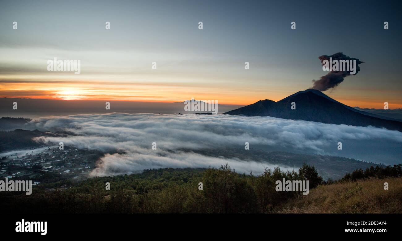 Volcano eruption at sunrise. Mount Agung, Bali, Indonesia Stock Photo