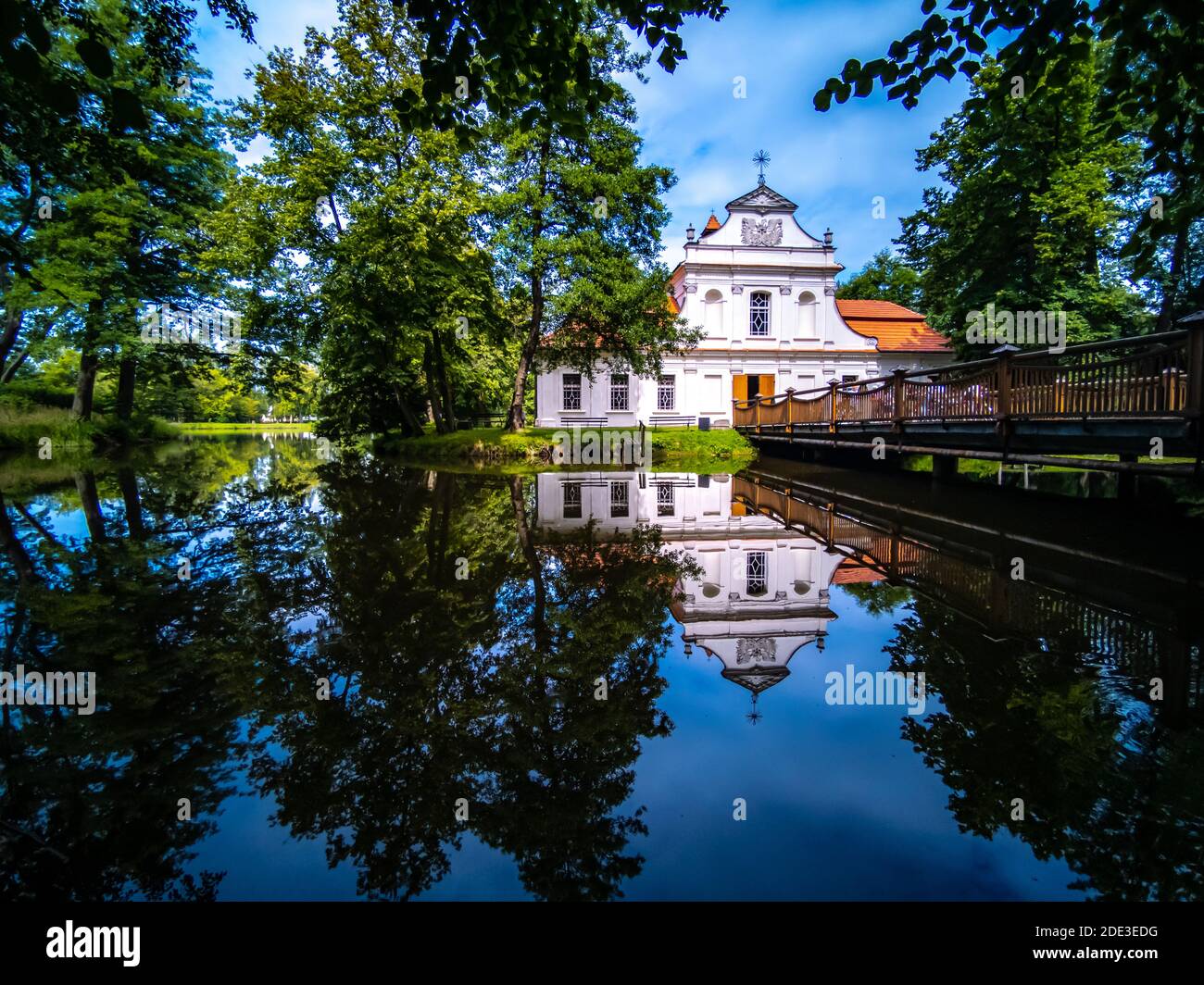 On a small island of the city pond, a small church has been built that provides a mirror image. Stock Photo