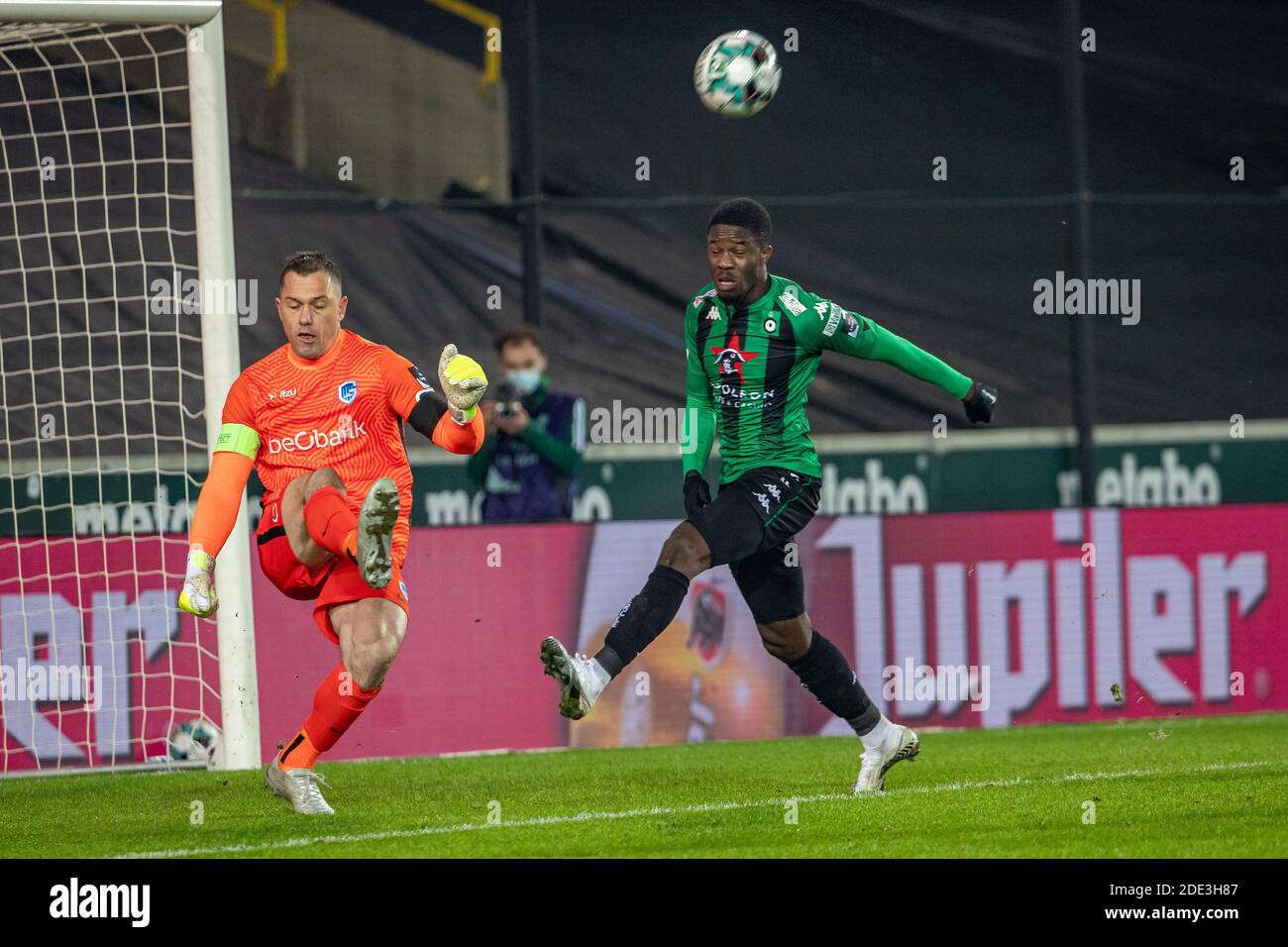 Genk's goalkeeper Daniel Danny Vukovic and Cercle's Ike Ugbo fight for the ball during a postponed soccer match between Cercle Brugge KSV and KRC Genk Stock Photo