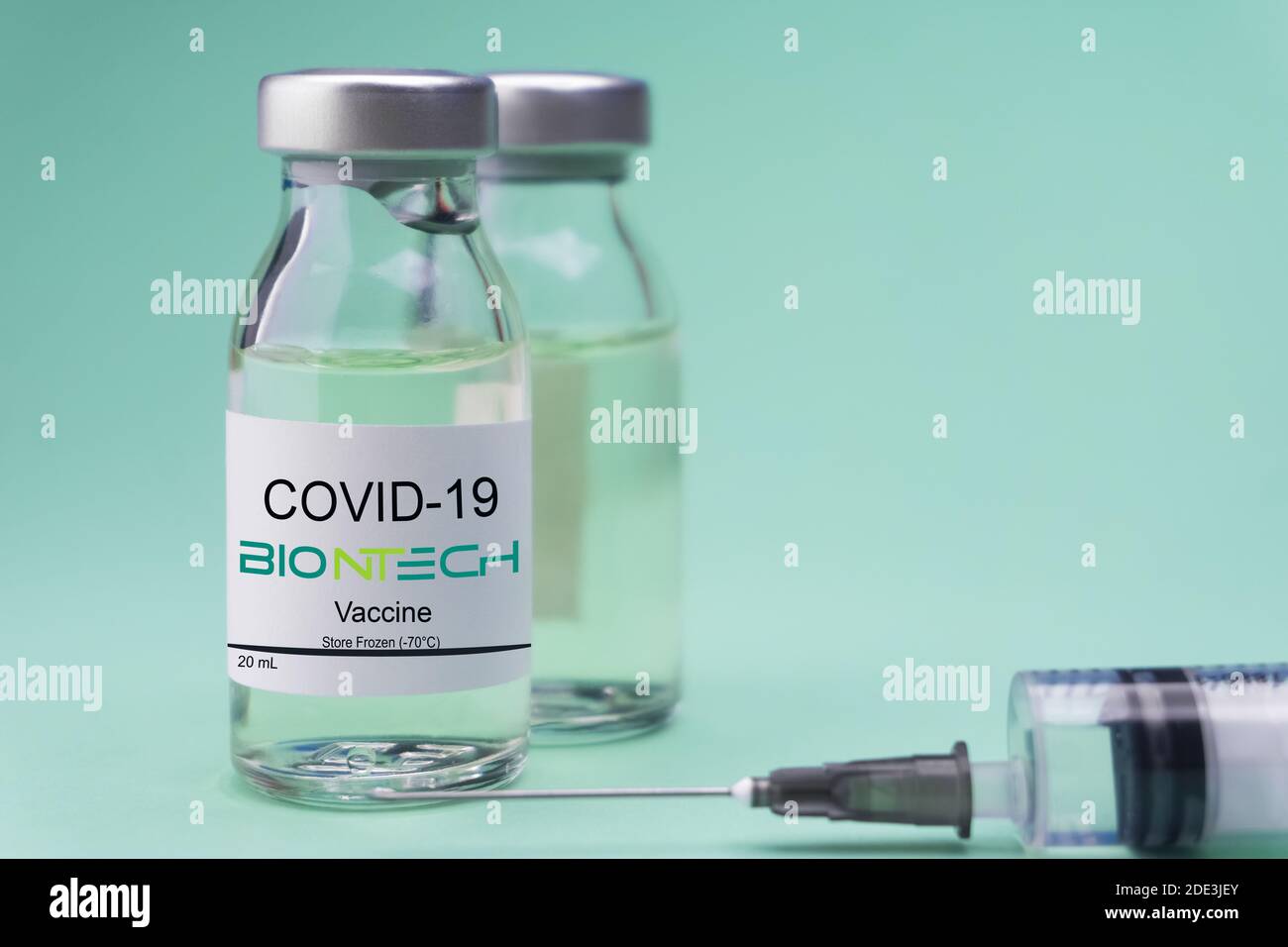Izmir, Turkey - November 18 2020: Coronavirus vaccine concept and background. New vaccine pfizer and biontech isolated on green background. Covid-19 Stock Photo