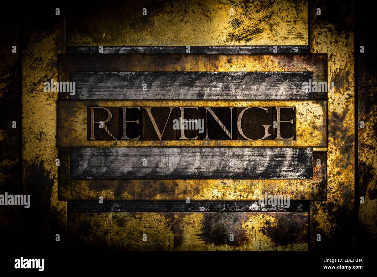 Revenge text on grunge copper and textured lead vintage gold background Stock Photo
