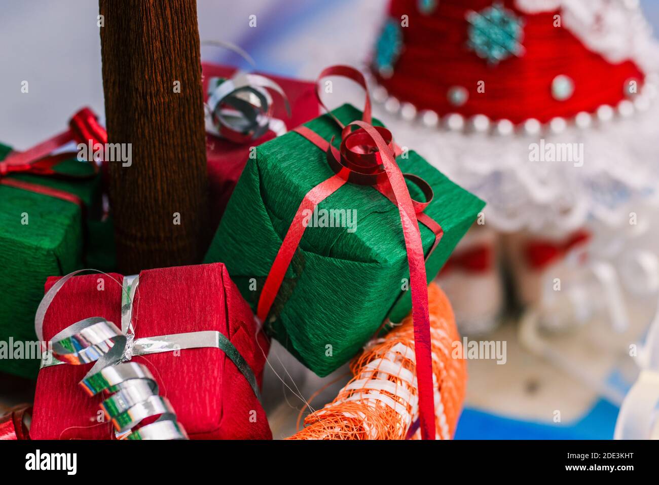 Gifts under the tree. Red and green boxes with ribbon. Christmas ...