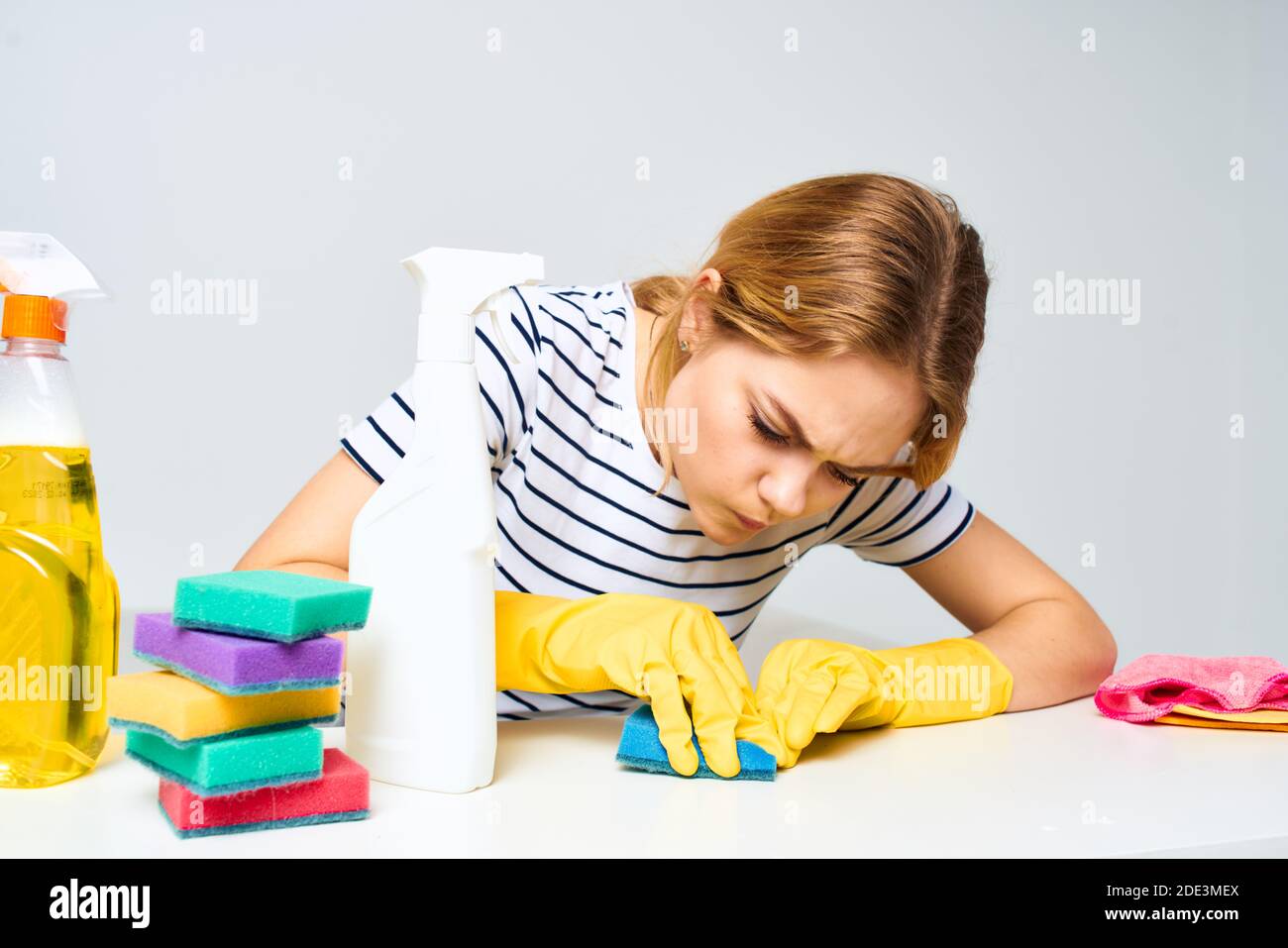 A cleaning lady sits at a table providing housekeeping services light
