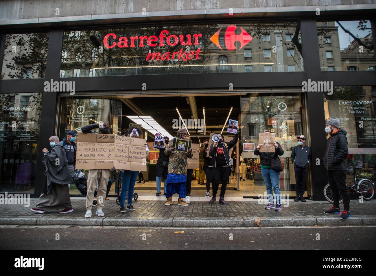 Protesters holding placards expressing their opinion in front of Carrefour  during the demonstration.The death of 40-year-old João Alberto Silveira, a  black man after receiving a brutal beating by Carrefour vigilantes in the