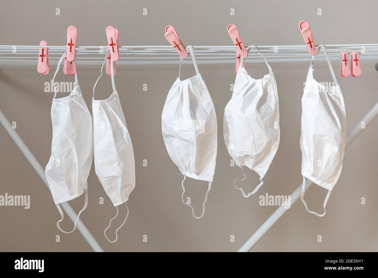 Used and washed face masks hanging on drying rack Stock Photo Alamy