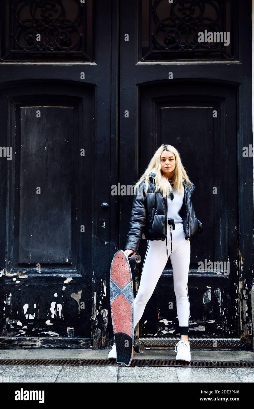 woman with a skateboard in hand Stock Photo