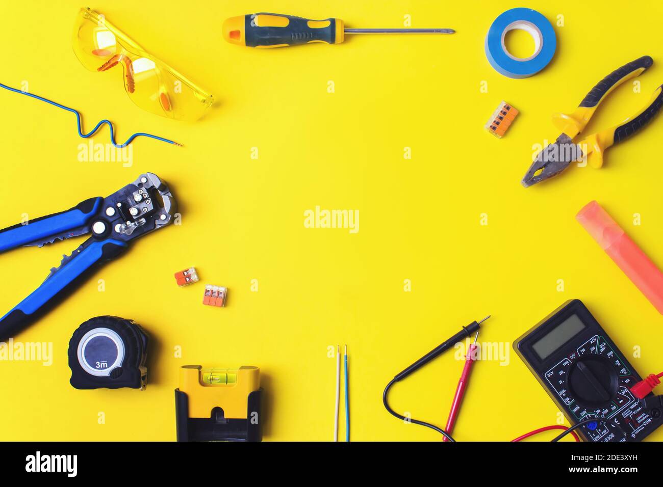 Set of electrician's tools on yellow background. Flat lay composition ...