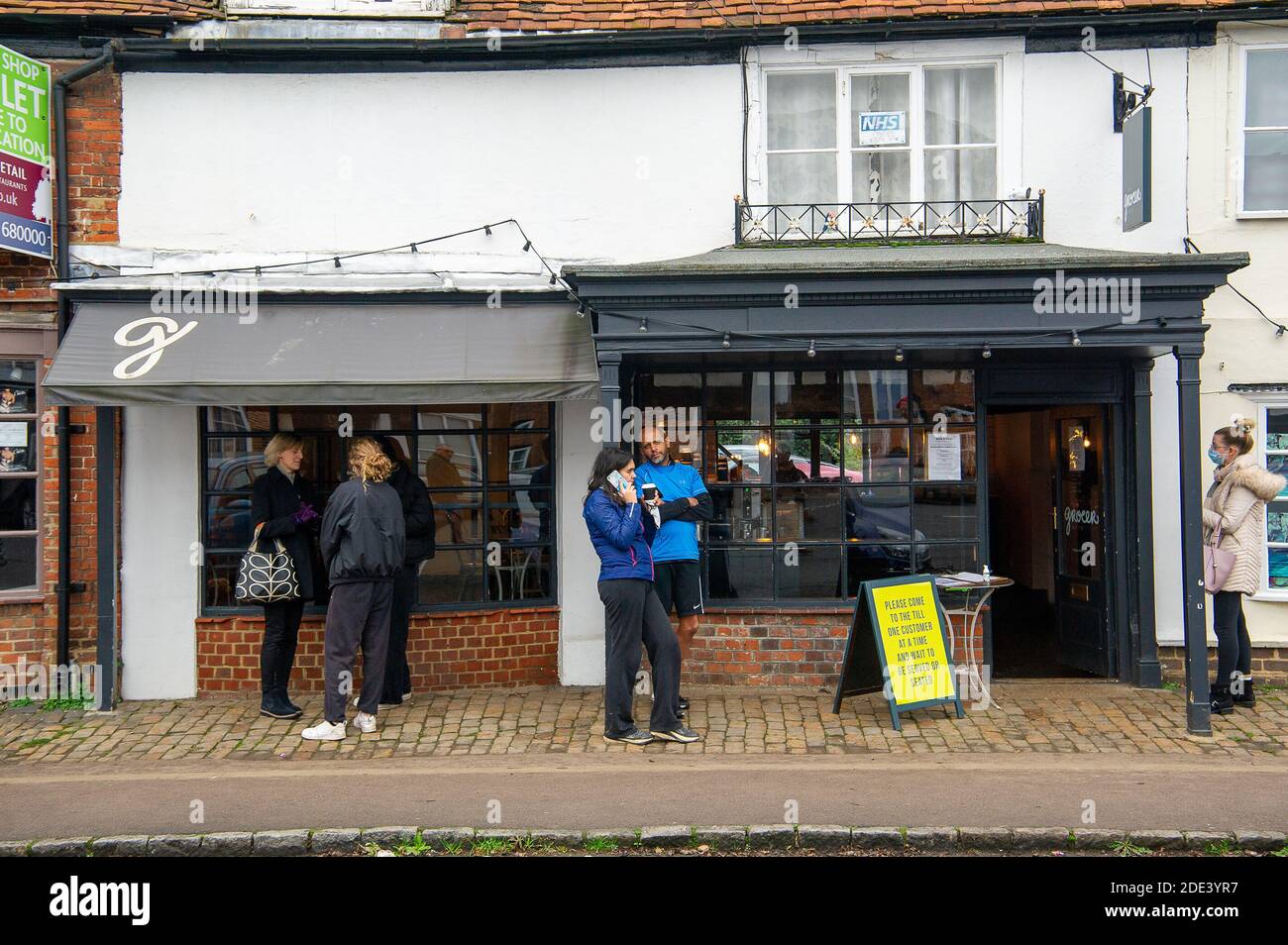 Amersham Old Town, Buckinghamshire, UK. 28th November, 2020. In the usually busy run up to Christmas as many shops stay closed during Covid-19 lockdown 2, locals were out walking today and enjoying take away coffees in the picturesque Amersham Old Town in Buckinghamshire. Credit: Maureen McLean/Alamy Live News Stock Photo