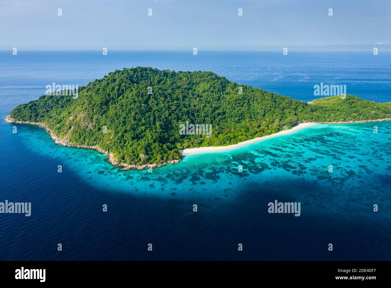 Aerial view of an empty beach on a beautiful tropical island surrounded by clear water and a coral reef (Andaman Sea) Stock Photo