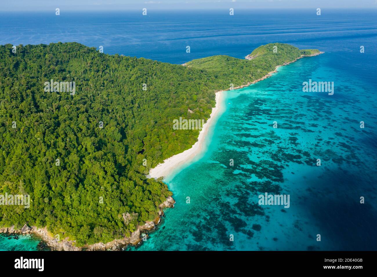 Aerial view of a deserted beach on a rugged tropical island surrounded by coral reef (Koh Tachai). Stock Photo