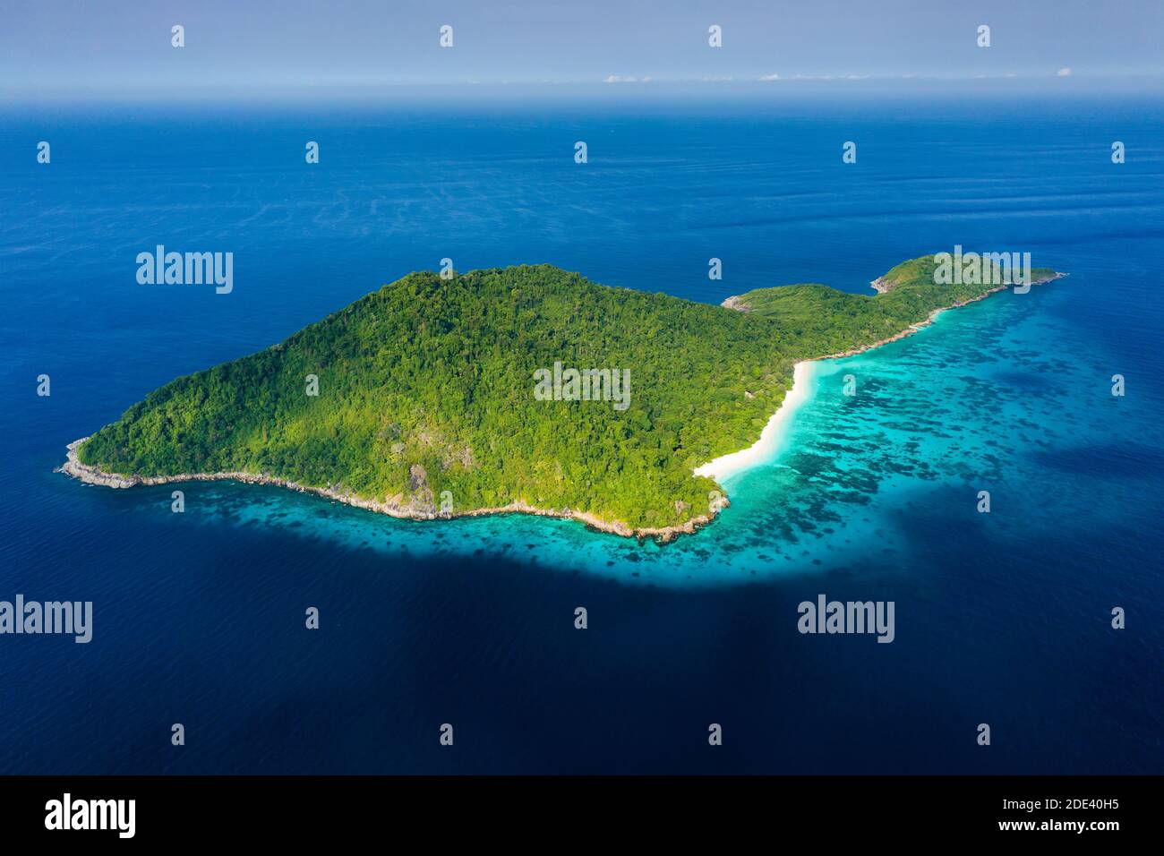 Aerial view of a deserted beach on a rugged tropical island surrounded by coral reef (Koh Tachai). Stock Photo