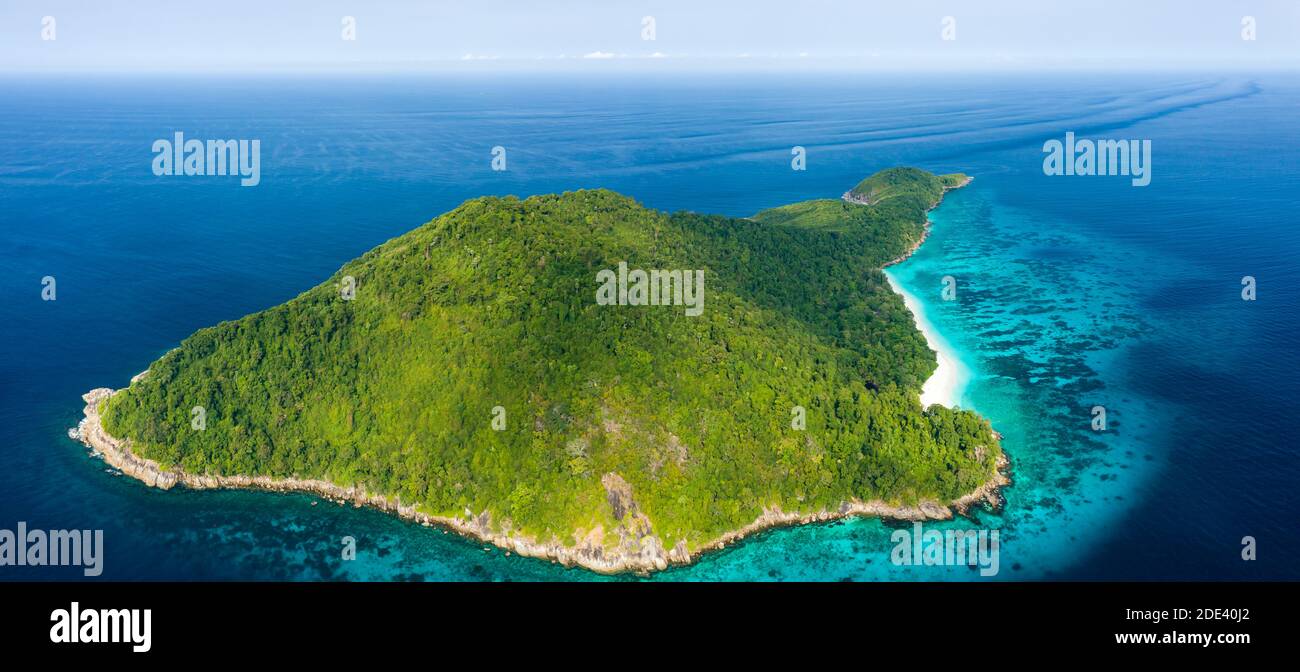 Aerial view of a beautiful tropical island surrounded by coral reef and a clear ocean Stock Photo