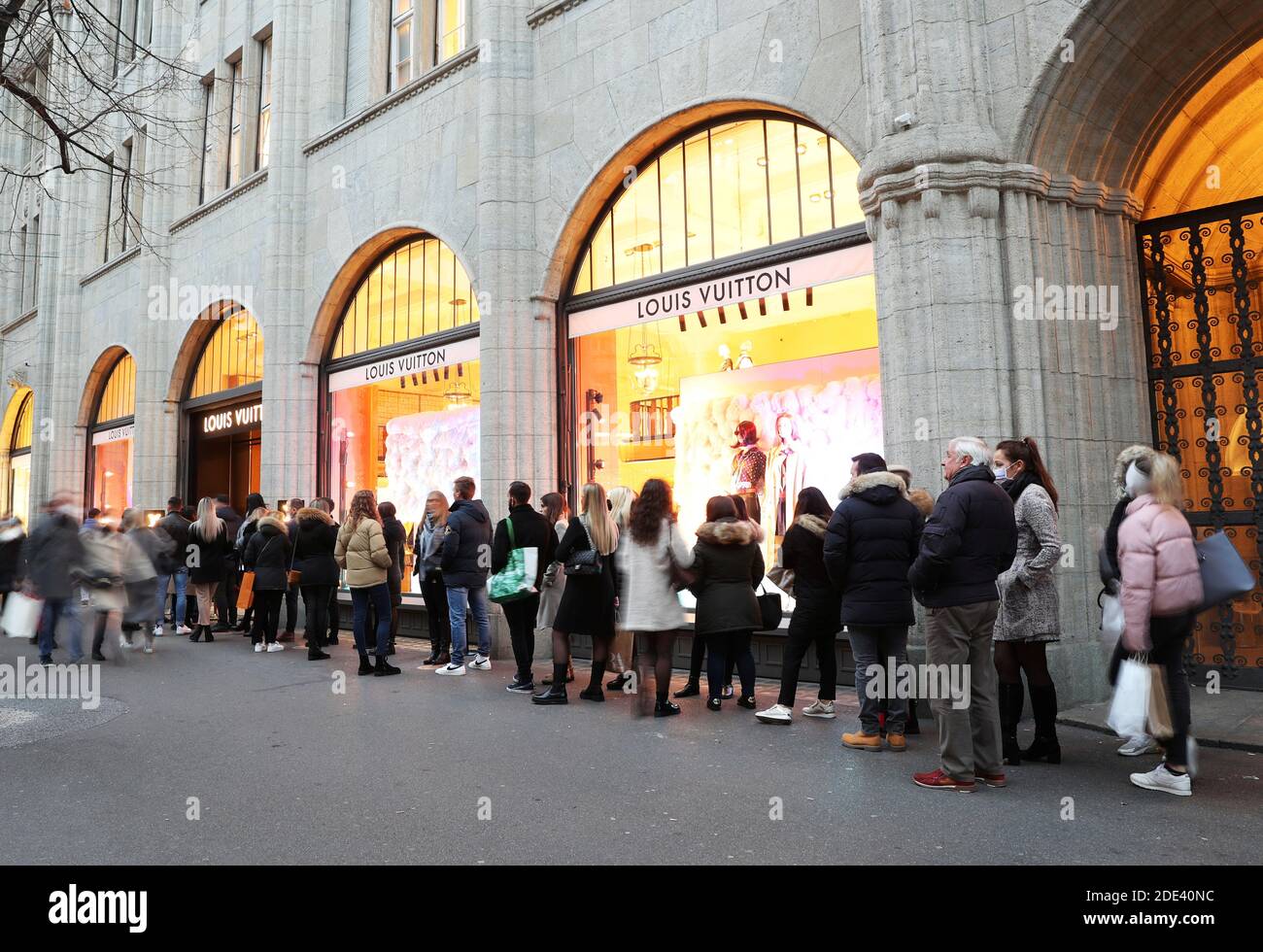 People queue in front of a store of the French luxury fashion brand Louis  Vuitton, as the spread of the coronavirus disease (COVID-19) continues, at  the Bahnhofstrasse shopping street in Zurich, Switzerland