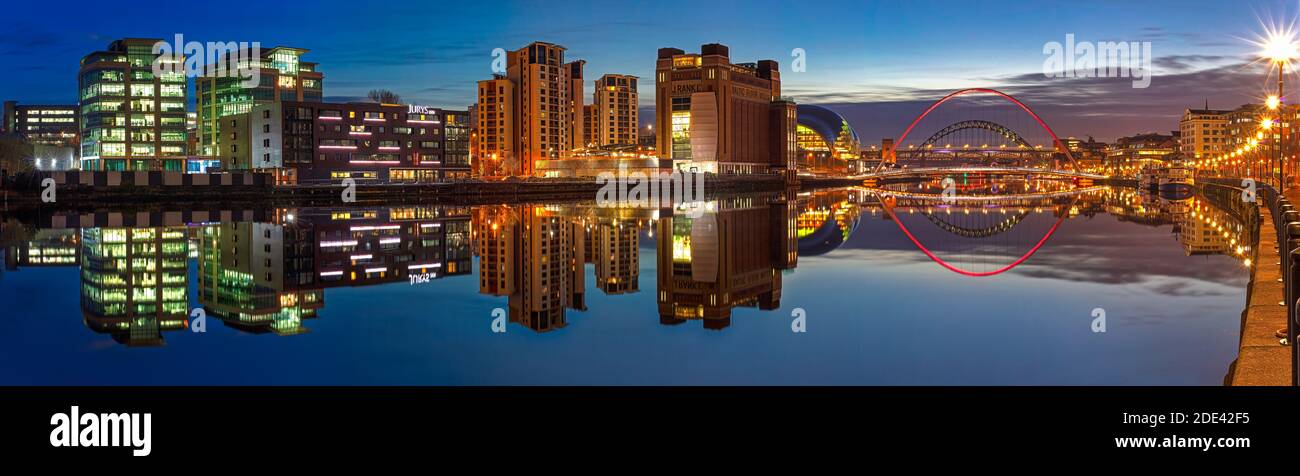 A view of Newcastle and Gateshead quays at dusk looking towards the Tyne Bridge from Newcastle quayside, Newcastle upon Tyne, Tyne and Wear, England, Stock Photo