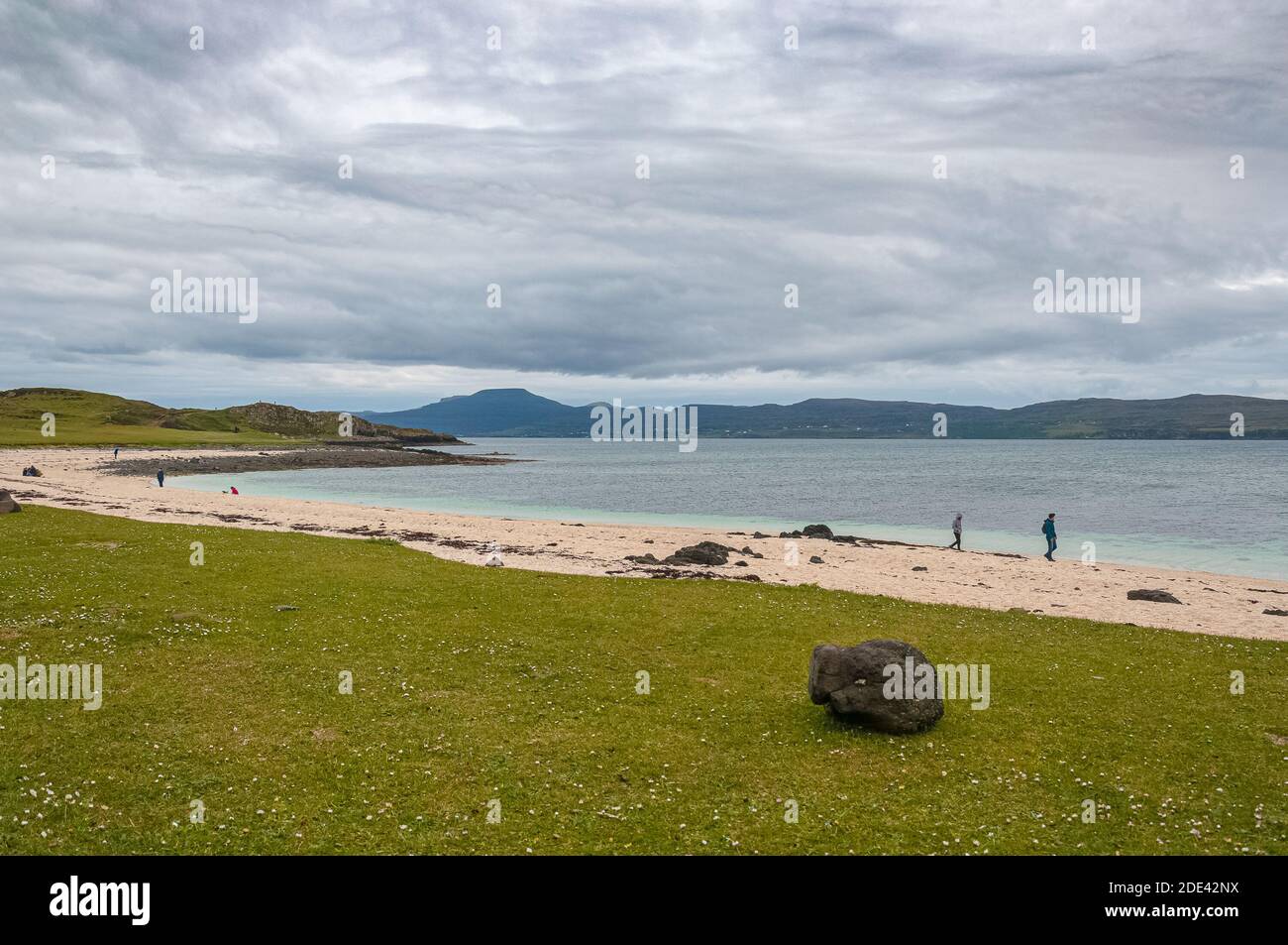 Isolated black stone on meadow, Coral Beach, Isle of Skye, Scotland. Concept: famous natural landscape, Scottish landscape, tranquility and serenity, Stock Photo