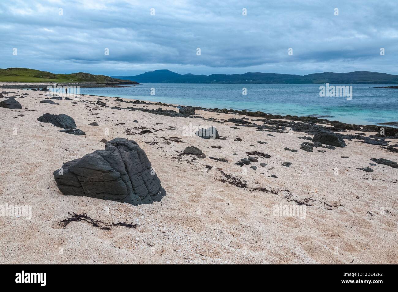 Black stones on white beach, Coral Beach, Isle of Skye, Scotland. Concept: famous natural landscape, Scottish landscape, tranquility and serenity, sea Stock Photo