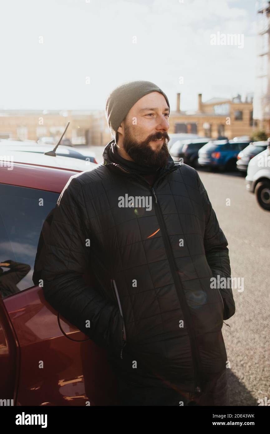 smiling bearded man dressed in winter clothes Stock Photo
