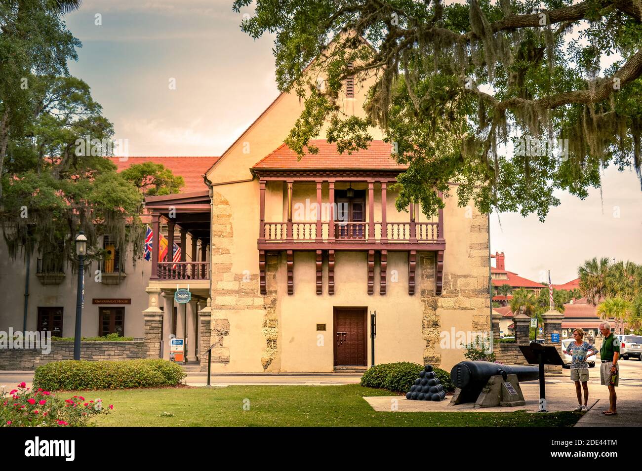 An older couple read historical marker with Civil war era cannon at the Government House, the Governor's Cultural Center and Museum, St. Augustine, FL Stock Photo