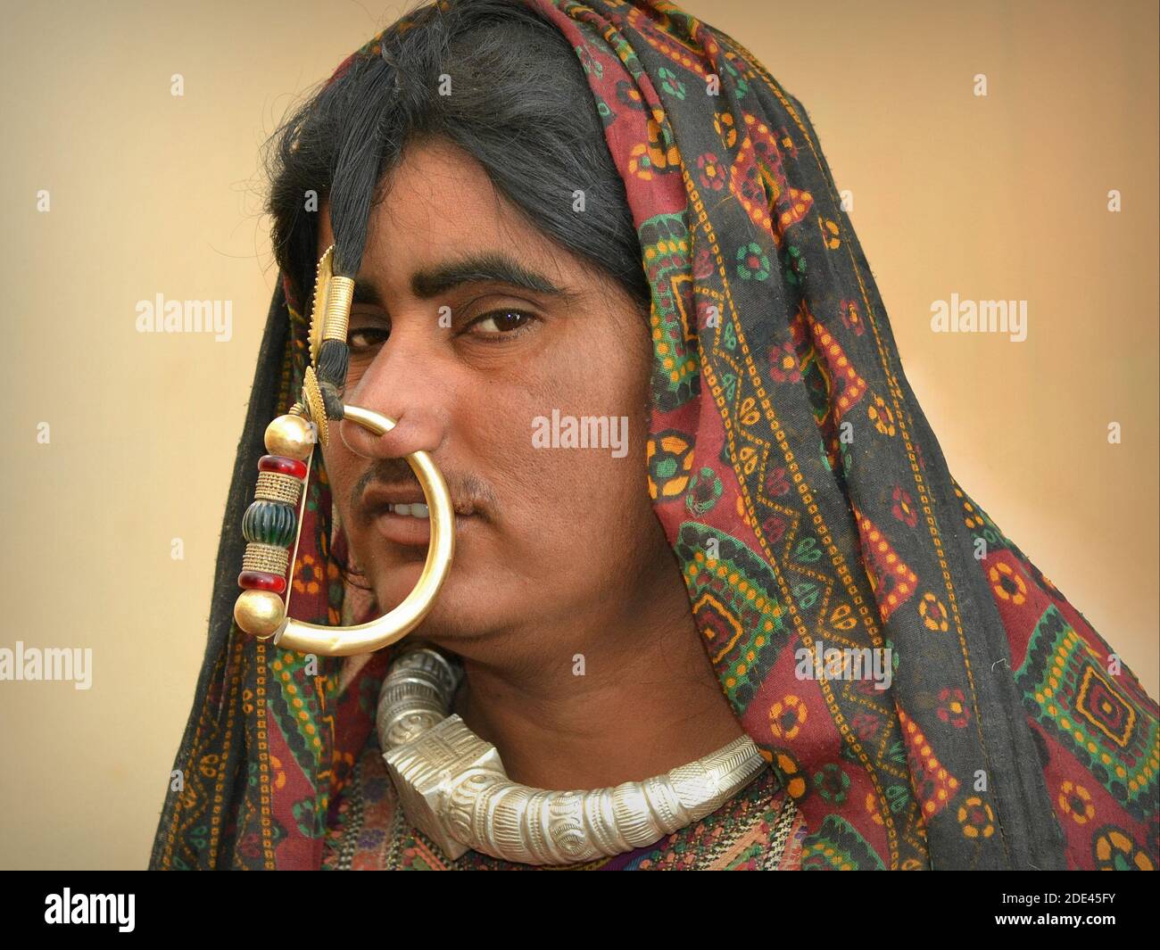 Young Indian Gujarati Jat tribal woman (Jats of Kutch) with large nostril piercing and heavy nose ring poses for the camera. Stock Photo