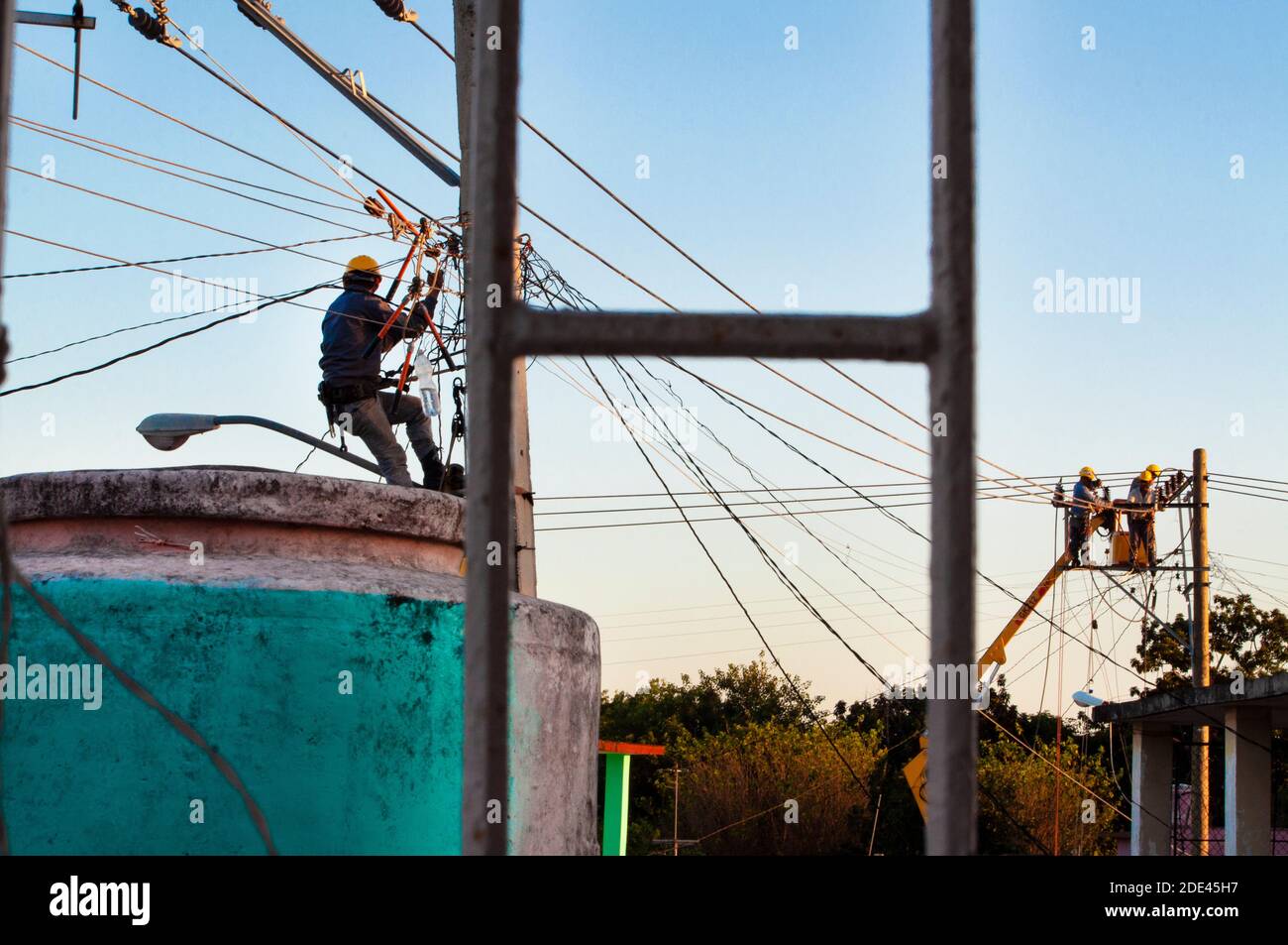 Electrician at work on a high voltage power line in the countryside, A  utility Lineman wearing a safety helmet rear view, AI Generated 24570238  Stock Photo at Vecteezy