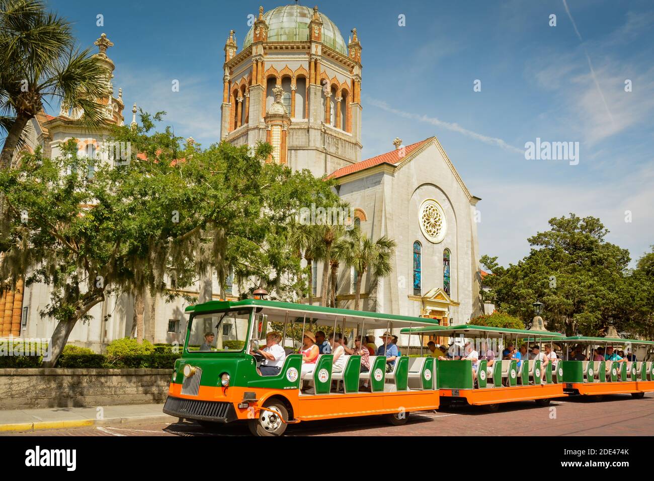 Open air tourist trolleys cruise Flagler Memorial Presbyterian Church, of Venetian Renaissance style, in honor of Jennie Flagler,  St. Augustine, FL Stock Photo