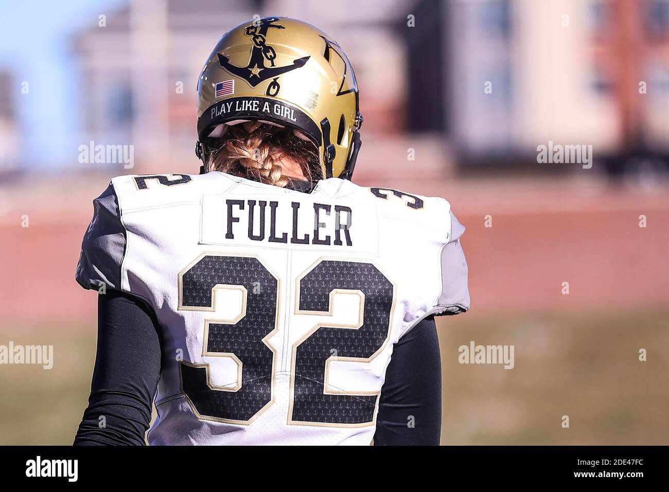 Attractive female american football player in uniform posing with helmet.  woman sportswoman. gender equality.