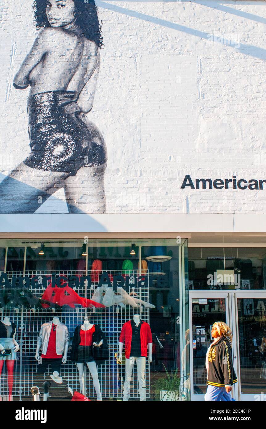 People walk past an American Apparel store in harlem New York, USA Stock Photo