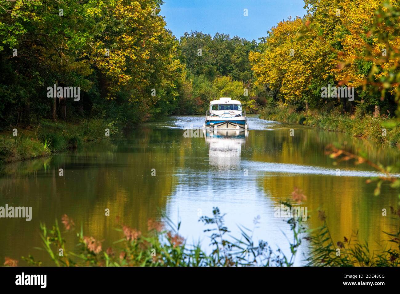 The Canal du Midi, near Carcassonne, French department of Aude, Occitanie Region, Languedoc-Rousillon France. Boats moored on the tree lined canal. T Stock Photo