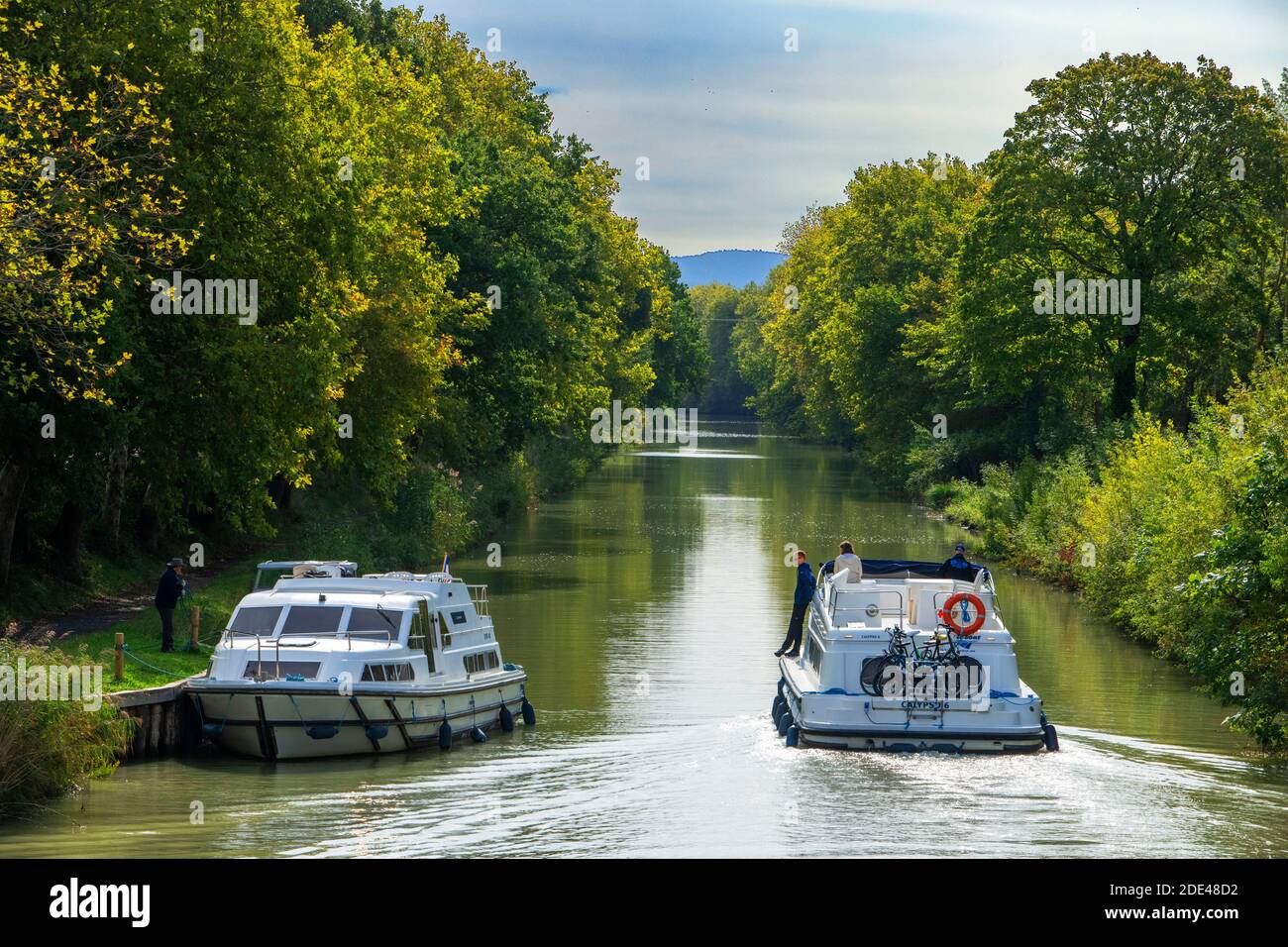 The Canal du Midi, near Carcassonne, French department of Aude, Occitanie Region, Languedoc-Rousillon France. Boats moored on the tree lined canal.  T Stock Photo
