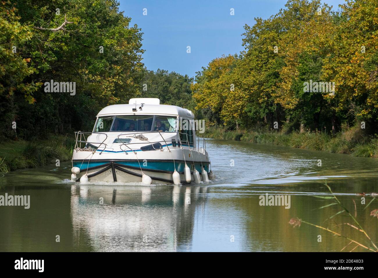 The Canal du Midi, near Carcassonne, French department of Aude, Occitanie Region, Languedoc-Rousillon France. Boats moored on the tree lined canal.  T Stock Photo