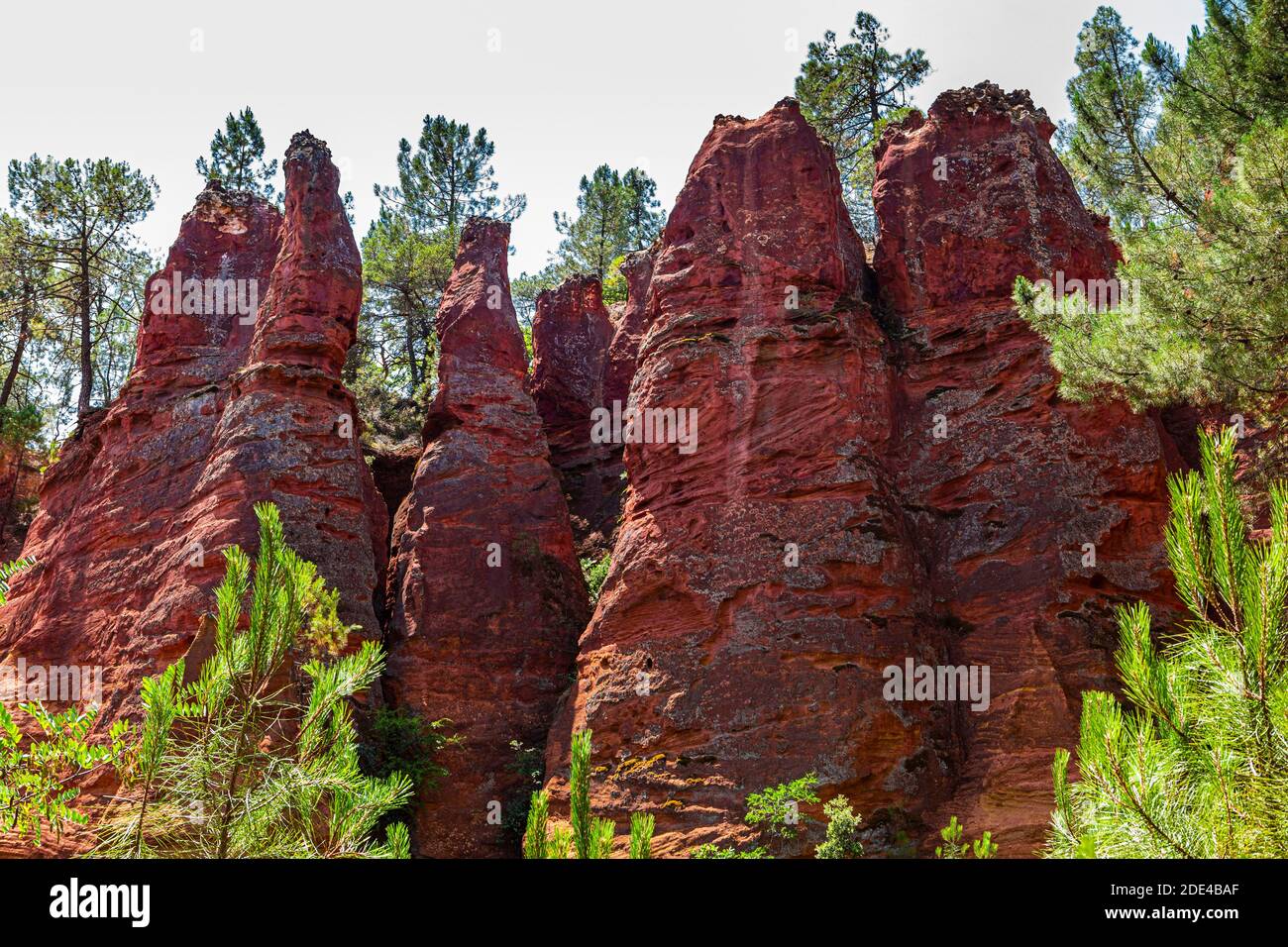 Red pyramid-shaped rocks in the natural park of ochre rocks in Roussillon, Luberon, Provence, France Stock Photo