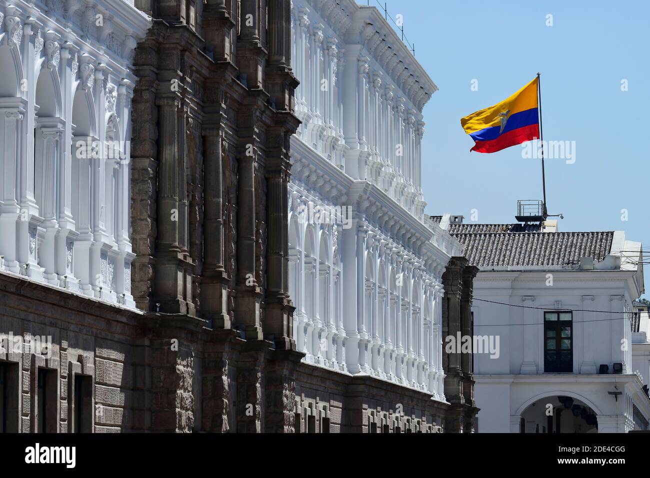 Waving national flag over the seat of government Palacio de Carondelet