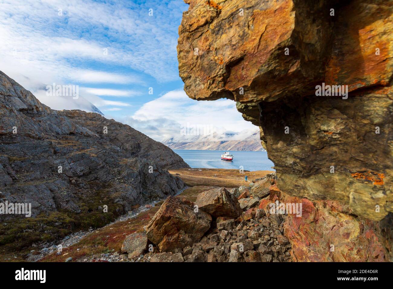 Cruise ship in fjord on the east coast of Greenland, rocks, lichens, Greenland, Denmark Stock Photo