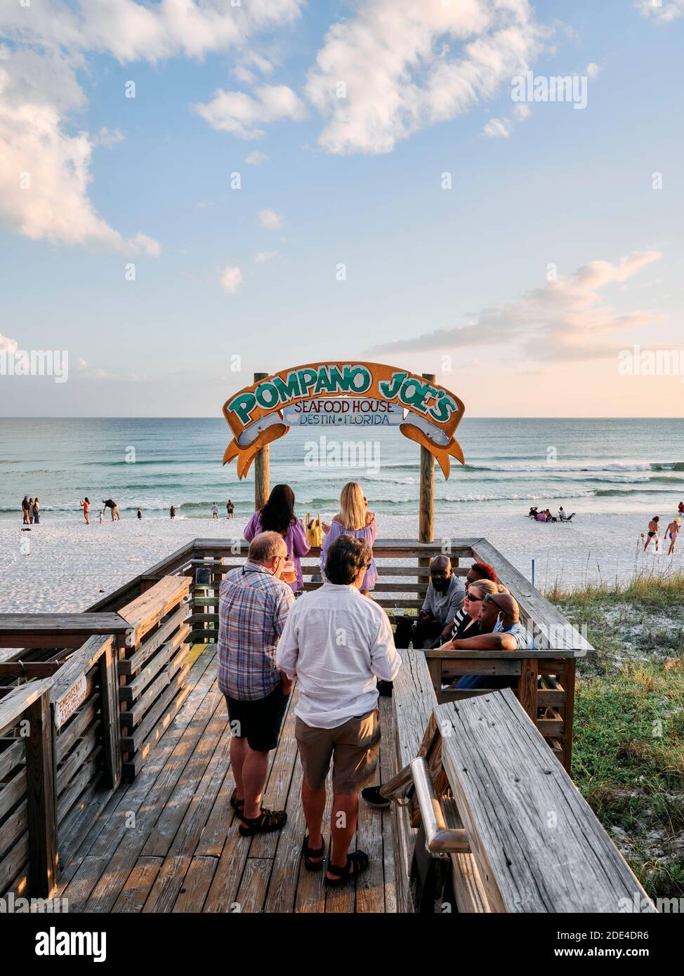 People relaxing on the deck of Pompano Joe's beach bar in south Walton County, in the Florida panhandle, Gulf Coast, Destin Florida, USA. Stock Photo